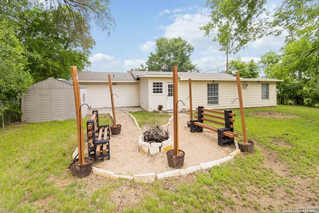 a view of a house with backyard porch and sitting area