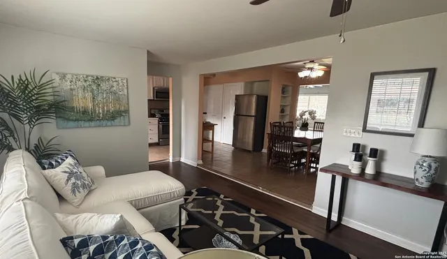 a living room with furniture and wooden floor