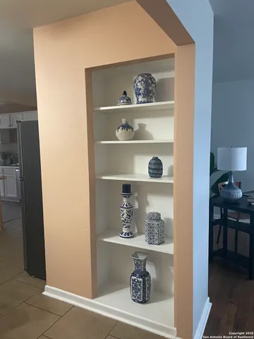 a shelf with cup and plates