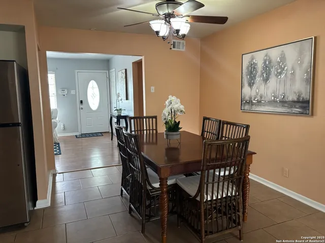 a view of a dining room with furniture and a chandelier