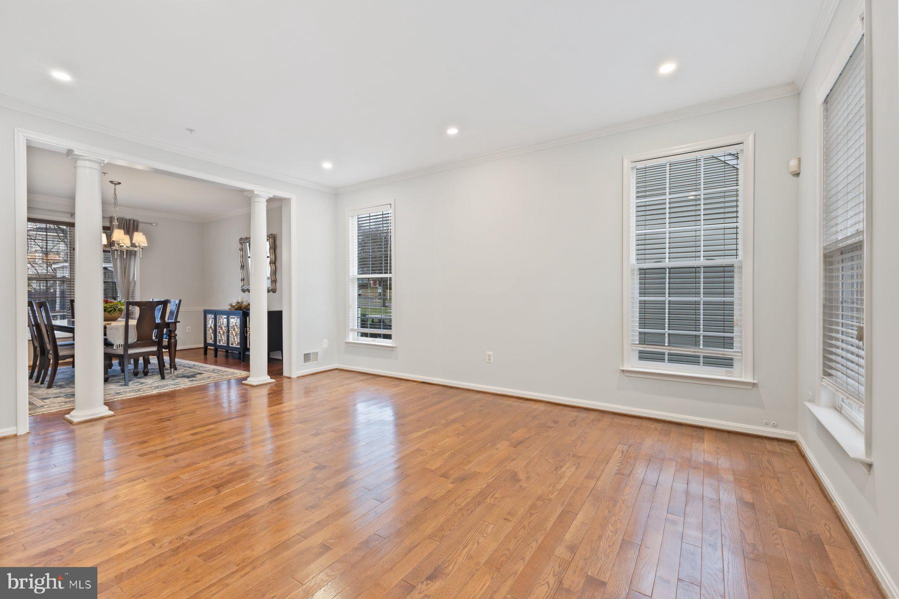 12003 Manchester Way Bowie, MD 20720 - Photo 11 of 49 a view of an empty room with wooden floor and a window