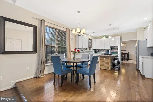 a dining room with furniture window and wooden floor