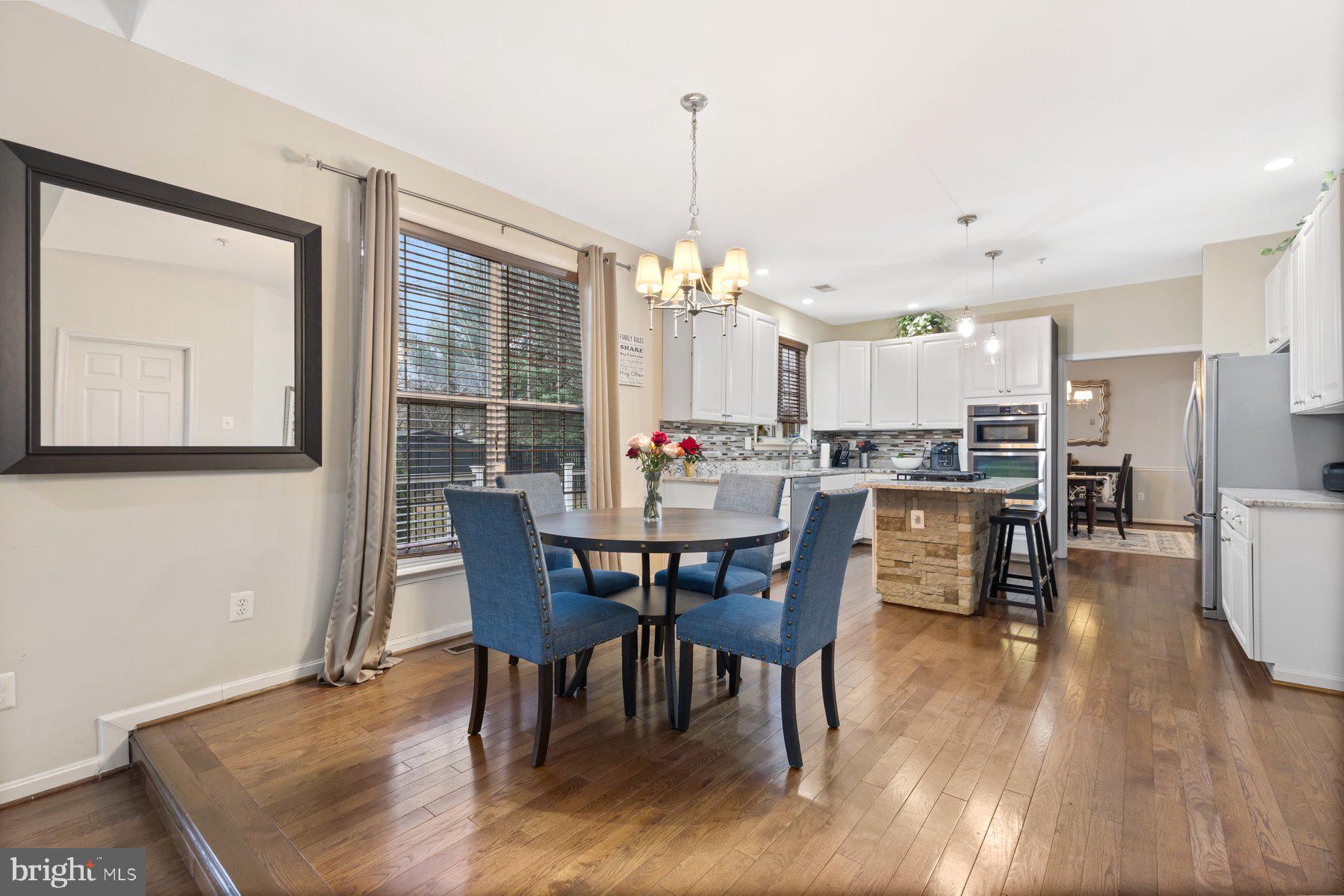 12003 Manchester Way Bowie, MD 20720 - Photo 18 of 49 a dining room with furniture window and wooden floor