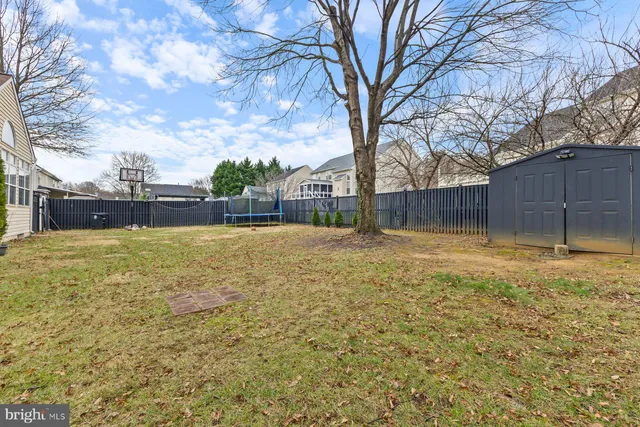 a swimming pool with outdoor seating and yard