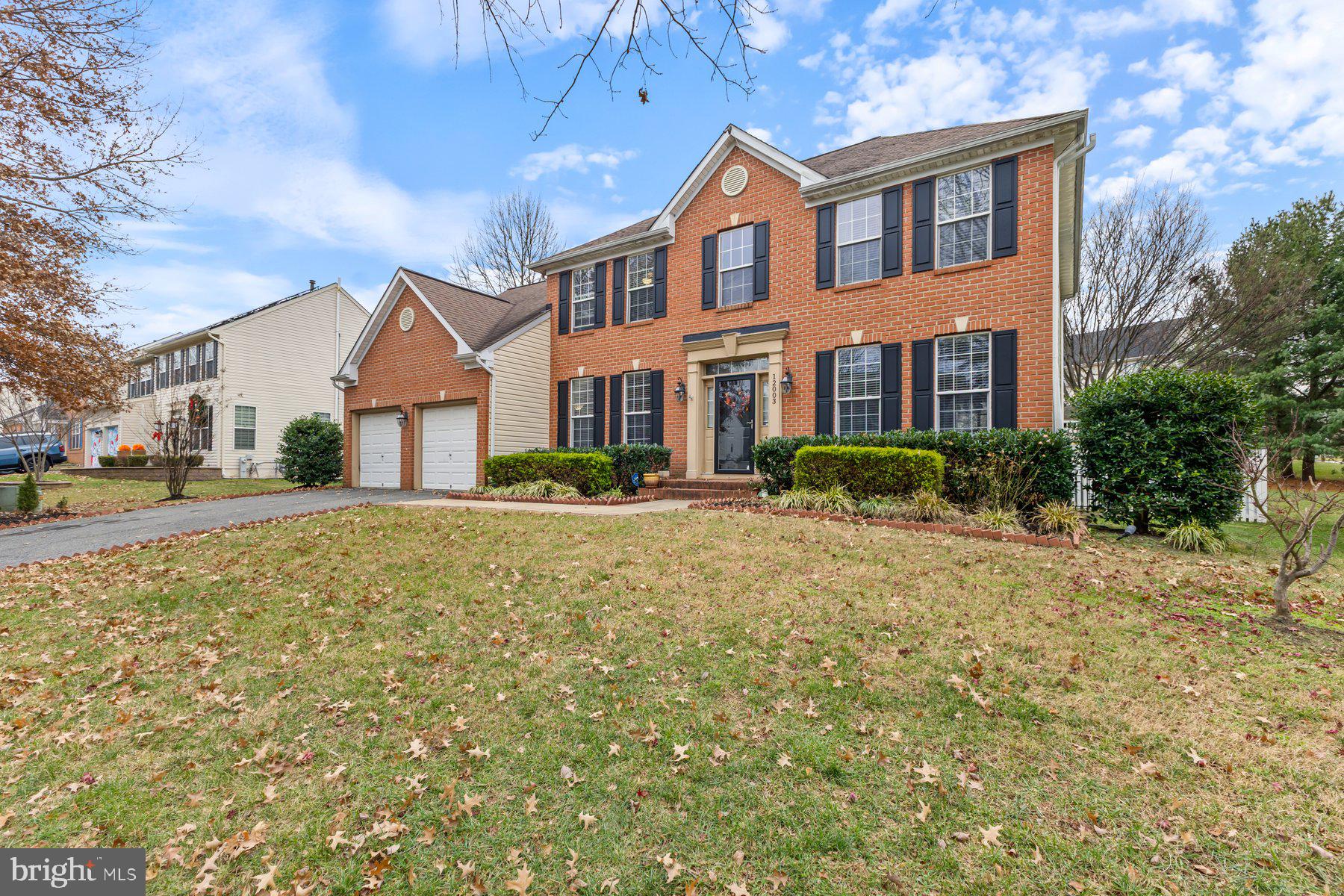 12003 Manchester Way Bowie, MD 20720 - Photo 3 of 49 a front view of a house with a yard