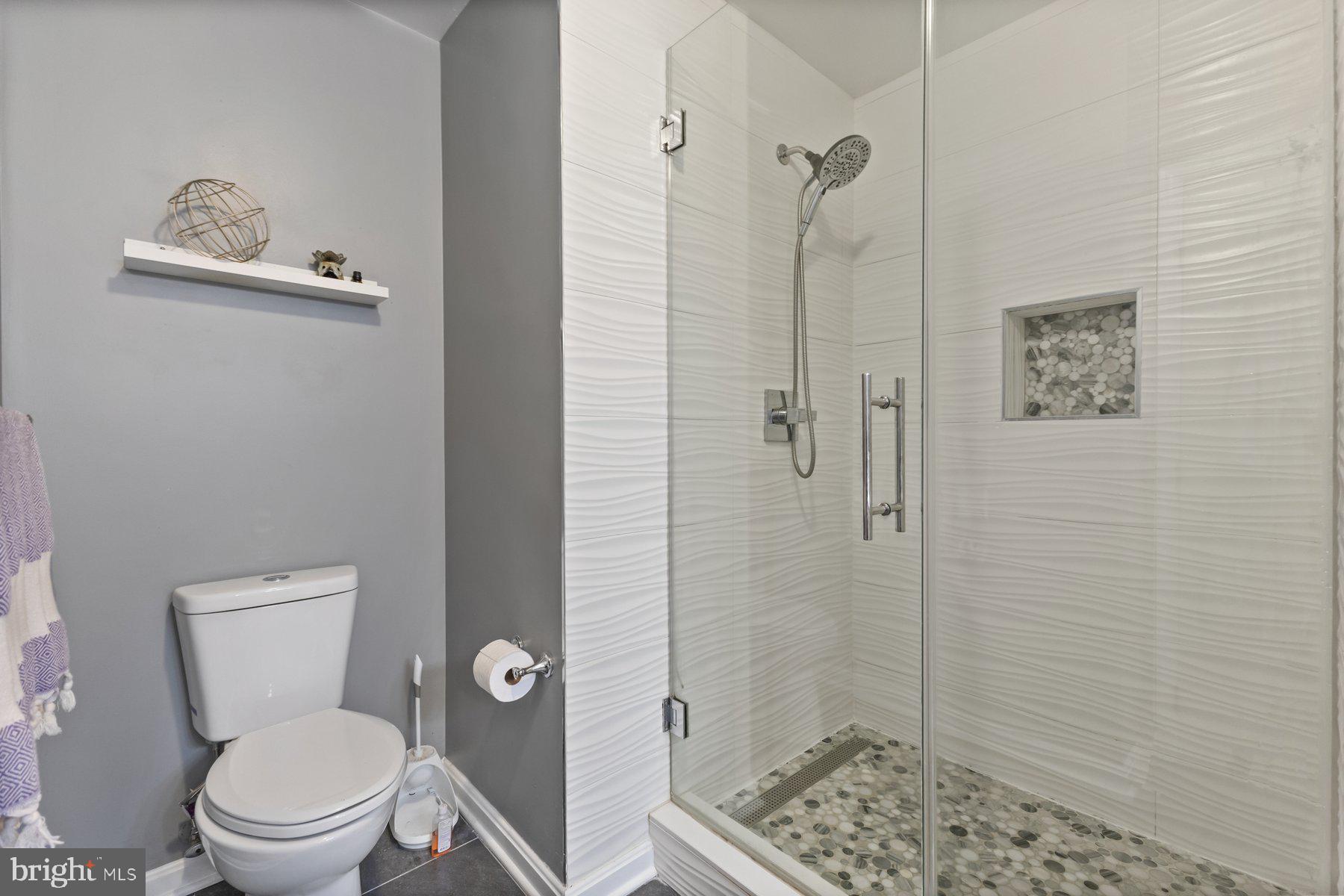 12003 Manchester Way Bowie, MD 20720 - Photo 36 of 49 a white toilet sitting next to a bathroom