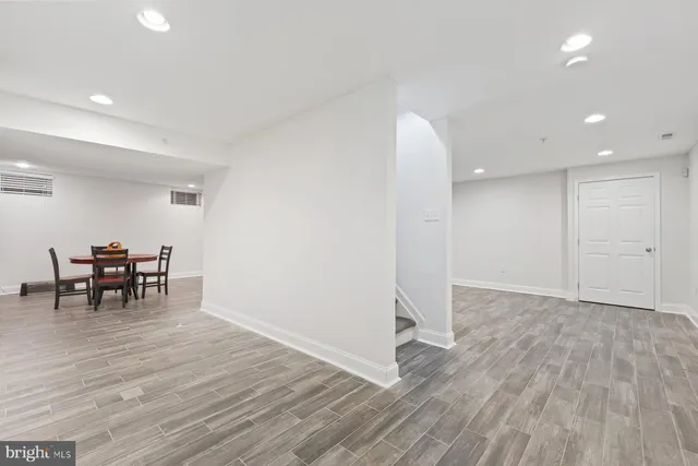 a view of work space with wooden floor and furniture