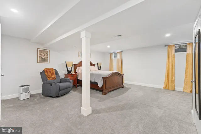 a bed room with furniture and a large window