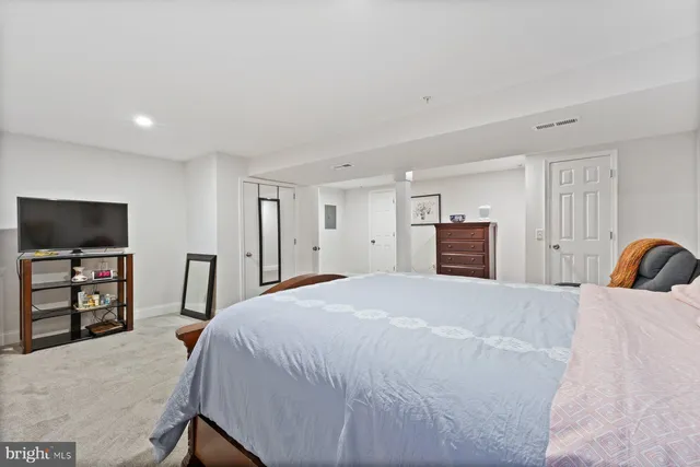 a bedroom with a bed and a flat screen television