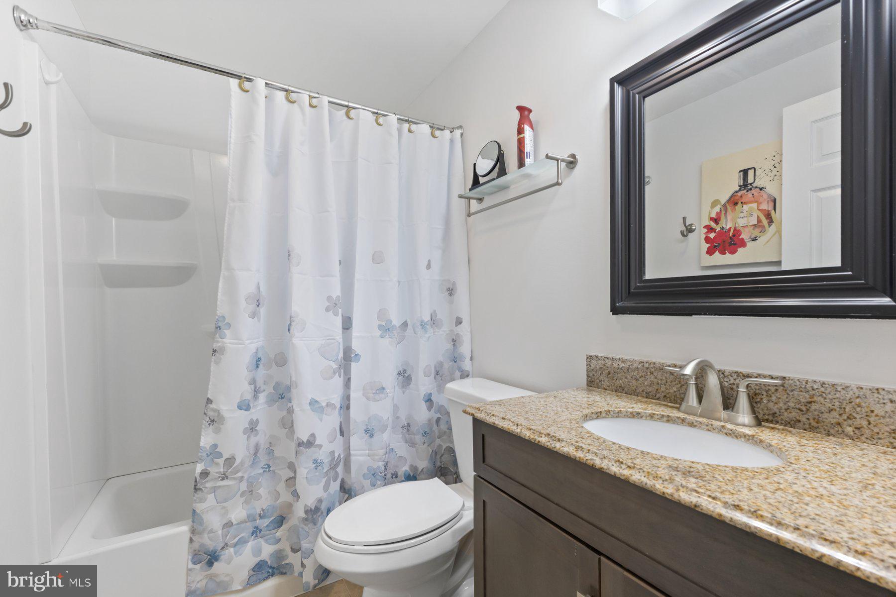 12003 Manchester Way Bowie, MD 20720 - Photo 49 of 49 a bathroom with a granite countertop sink a toilet and a shower curtain