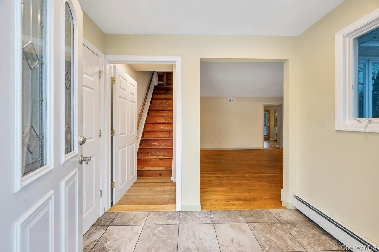 105 Browns Road Nesconset, NY 11767 - Photo 13 of 50 a view of a hallway with wooden floor and entryway
