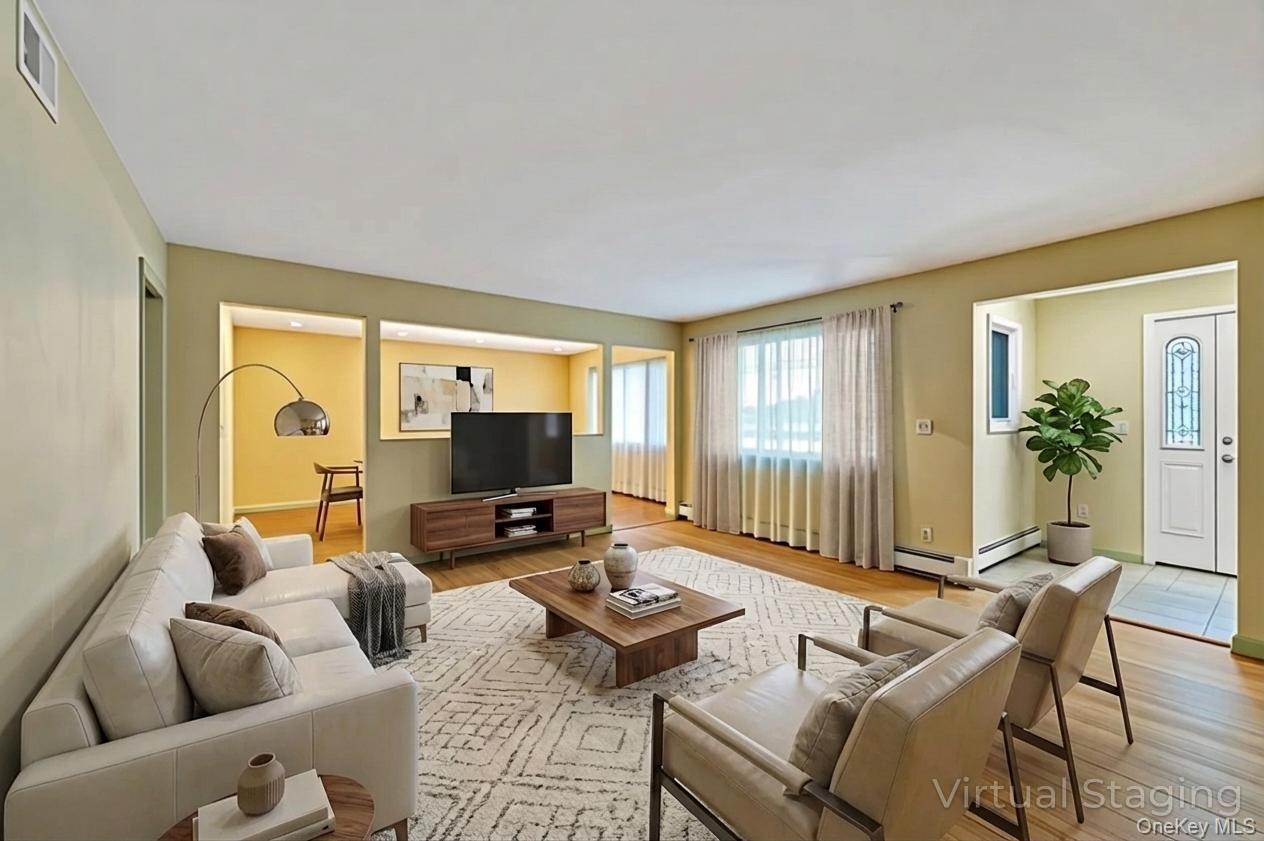 105 Browns Road Nesconset, NY 11767 - Photo 15 of 50 a living room with furniture and a flat screen tv