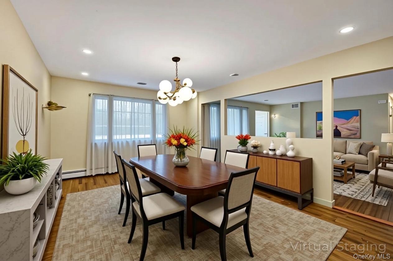 105 Browns Road Nesconset, NY 11767 - Photo 18 of 50 a view of a dining room with furniture and chandelier