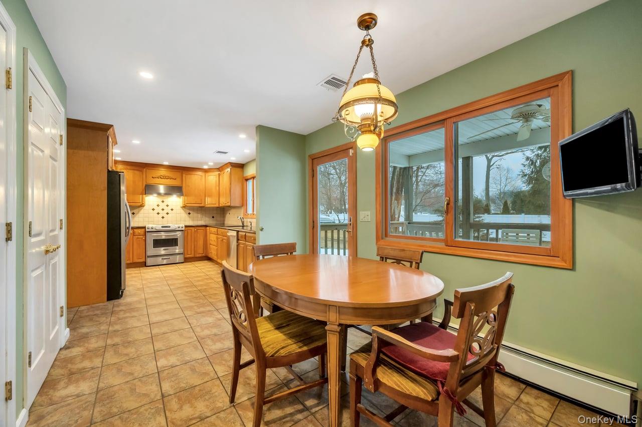 105 Browns Road Nesconset, NY 11767 - Photo 20 of 50 a view of a dining room with furniture wooden floor and chandelier