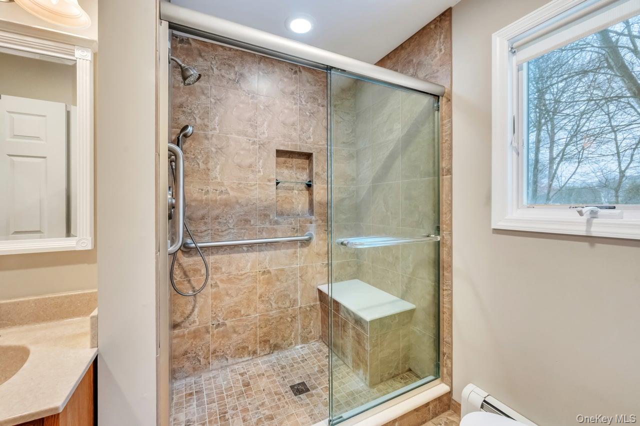 105 Browns Road Nesconset, NY 11767 - Photo 26 of 50 a bathroom with a glass shower door
