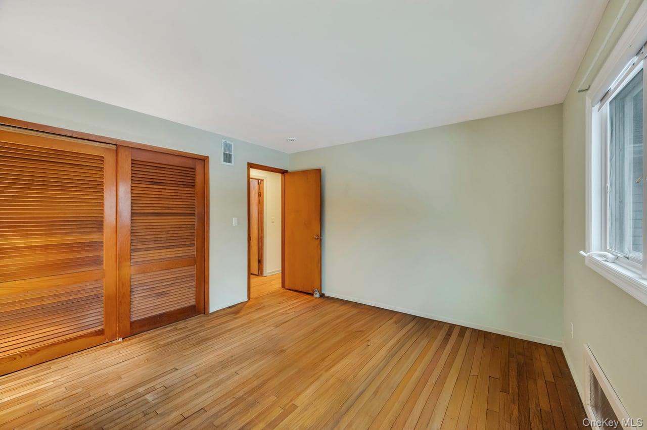 105 Browns Road Nesconset, NY 11767 - Photo 28 of 50 wooden floor in an empty room with a window
