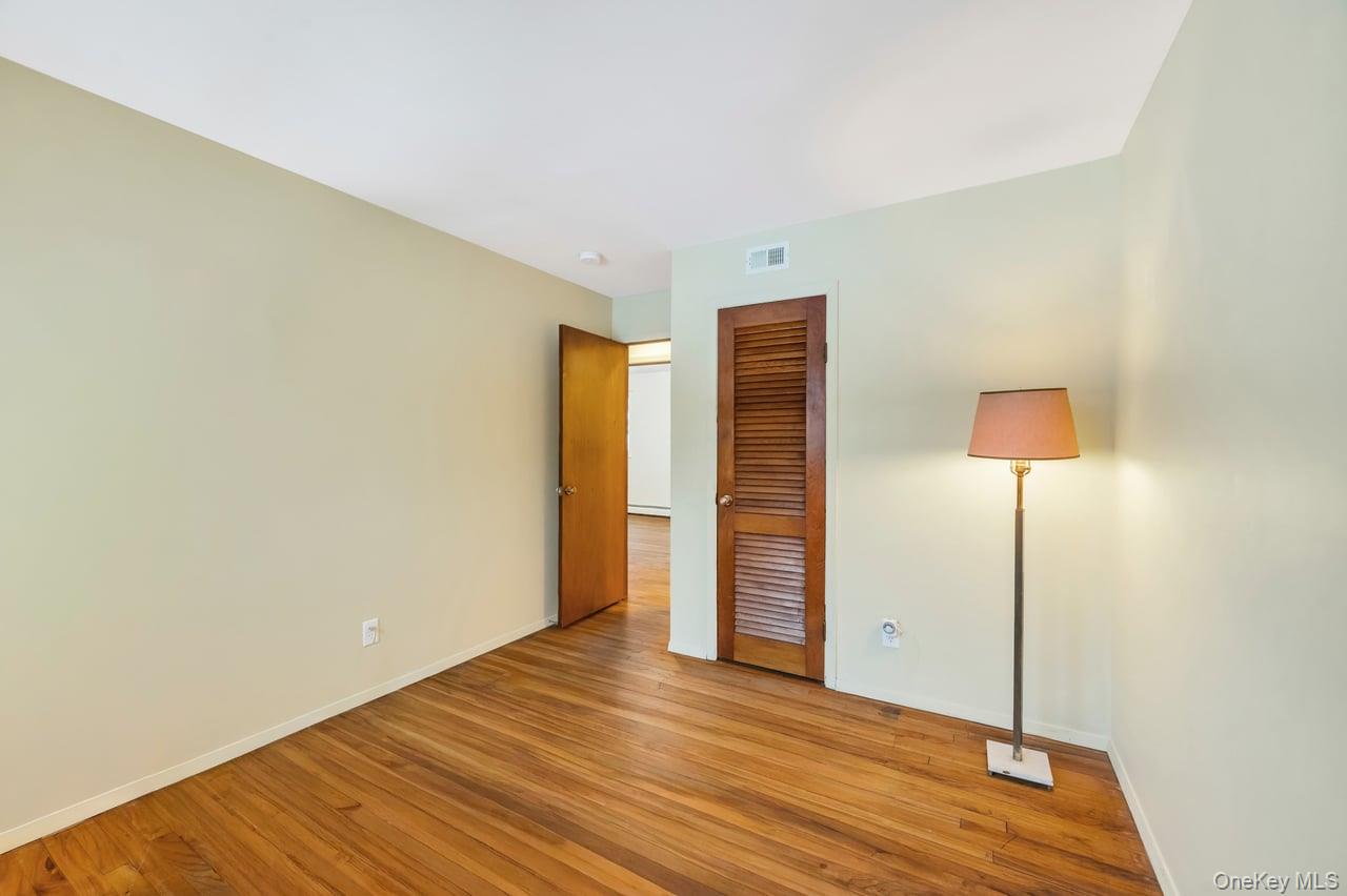 105 Browns Road Nesconset, NY 11767 - Photo 31 of 50 a view of an empty room with wooden floor