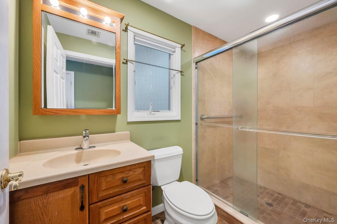 105 Browns Road Nesconset, NY 11767 - Photo 34 of 50 a bathroom with a sink a toilet and shower