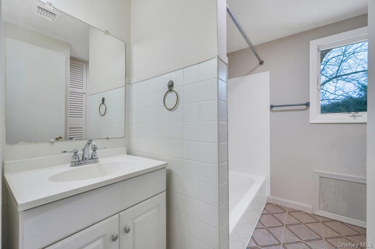 105 Browns Road Nesconset, NY 11767 - Photo 43 of 50 a bathroom with a sink toilet and shower