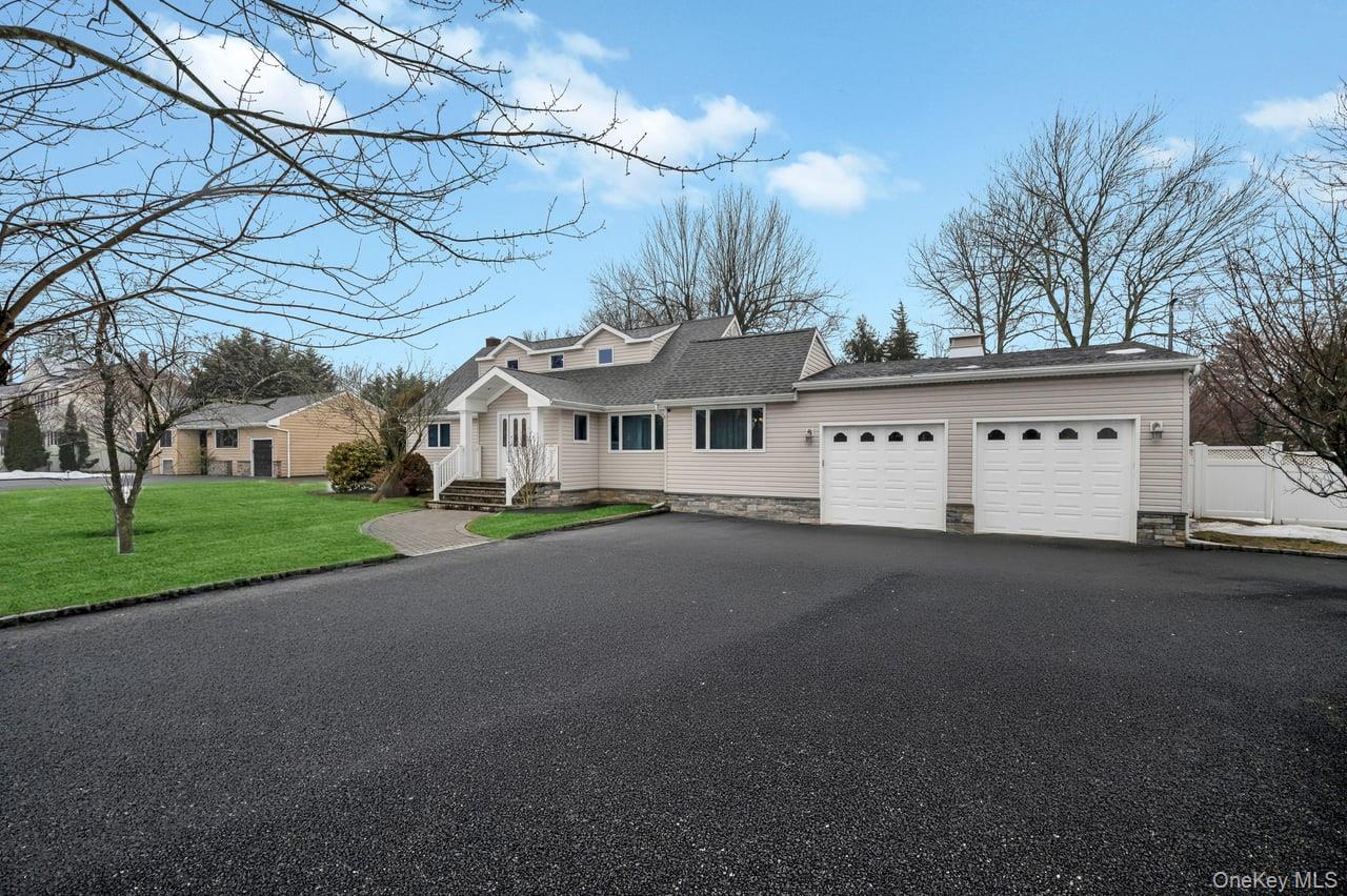 105 Browns Road Nesconset, NY 11767 - Photo 7 of 50 a view of a white house with a big yard and large tree
