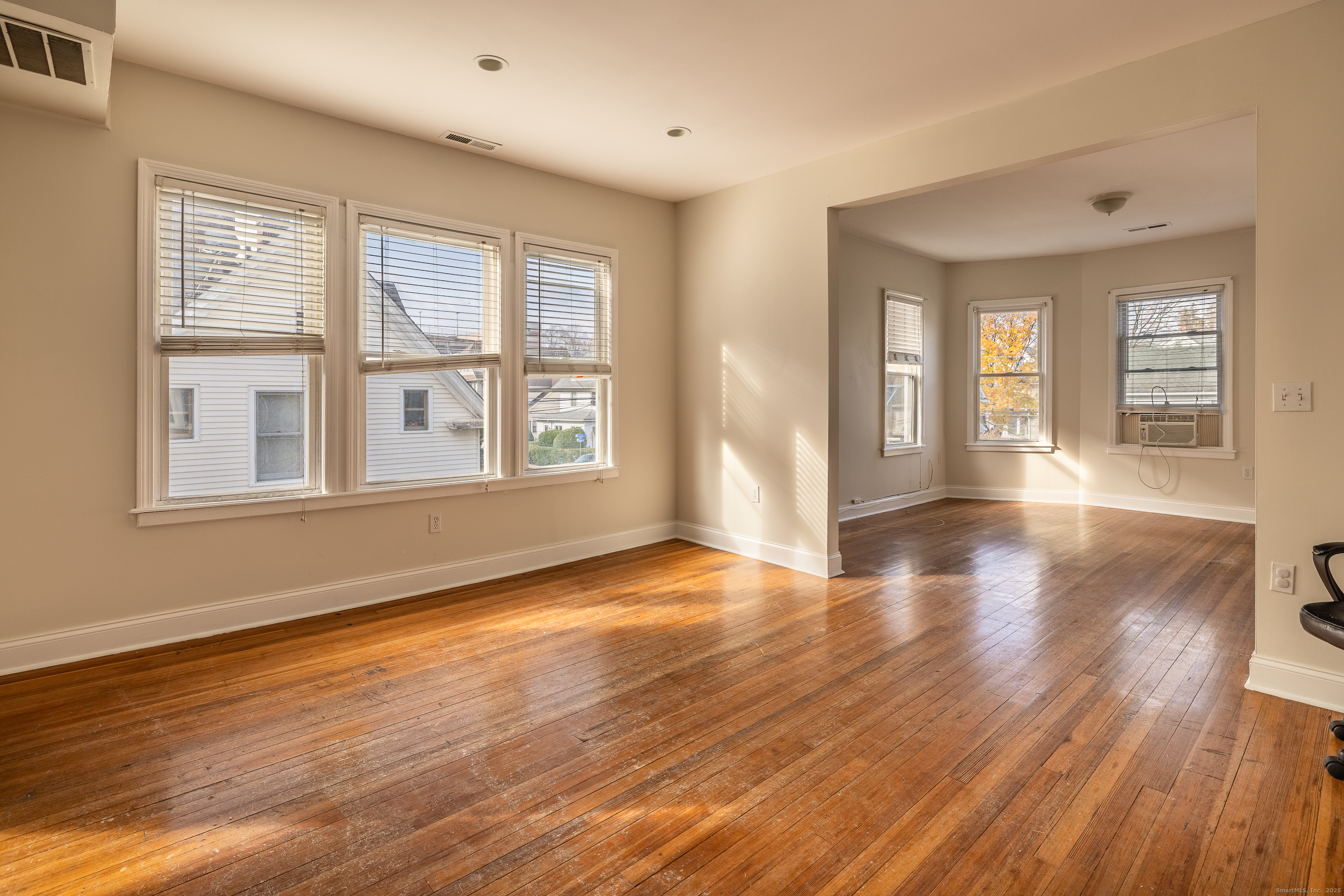 25 Hunting Street Bridgeport, CT 06606 - Photo 11 of 26 a view of an empty room with wooden floor and a window