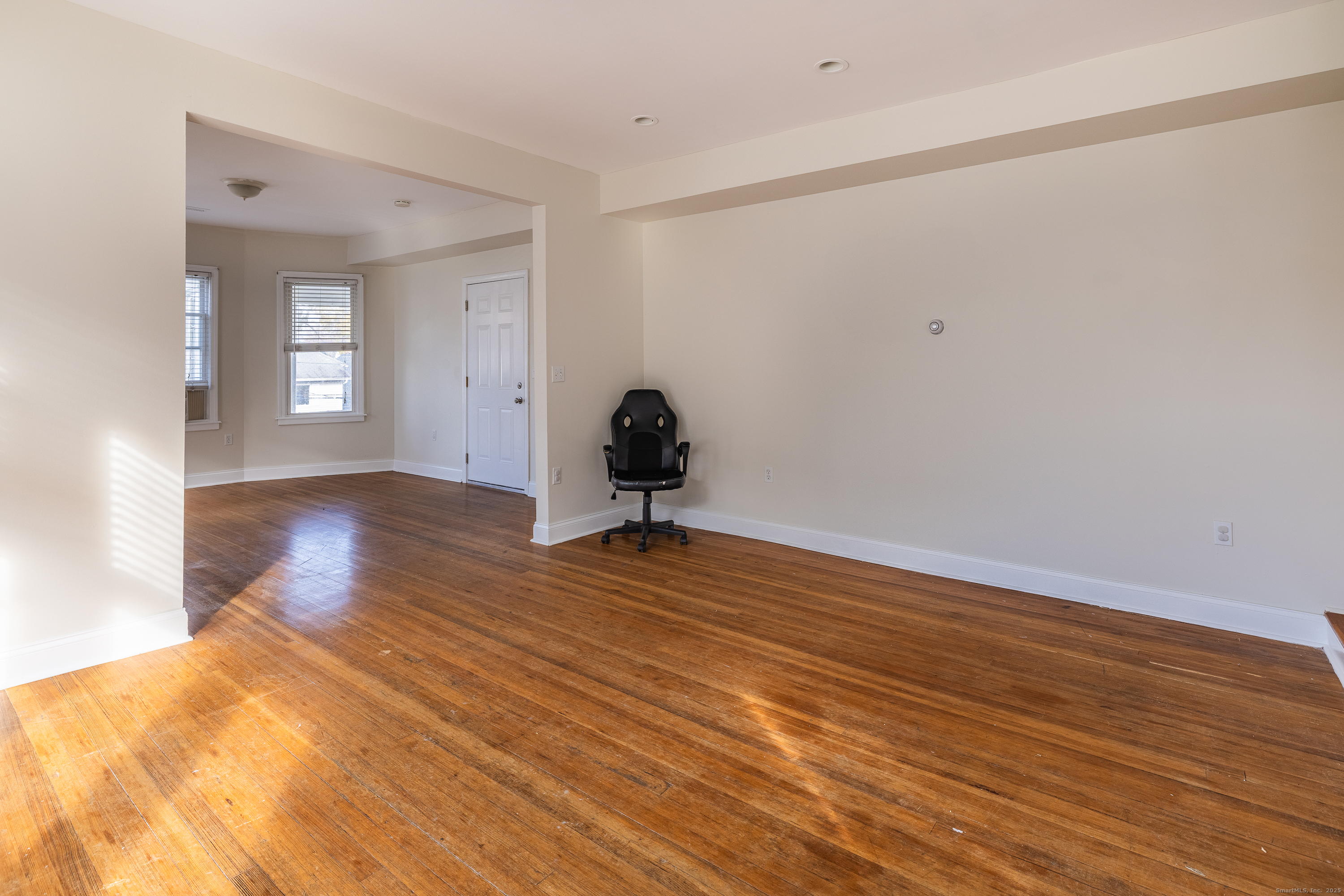 25 Hunting Street Bridgeport, CT 06606 - Photo 12 of 26 a view of a livingroom with wooden floor and a window