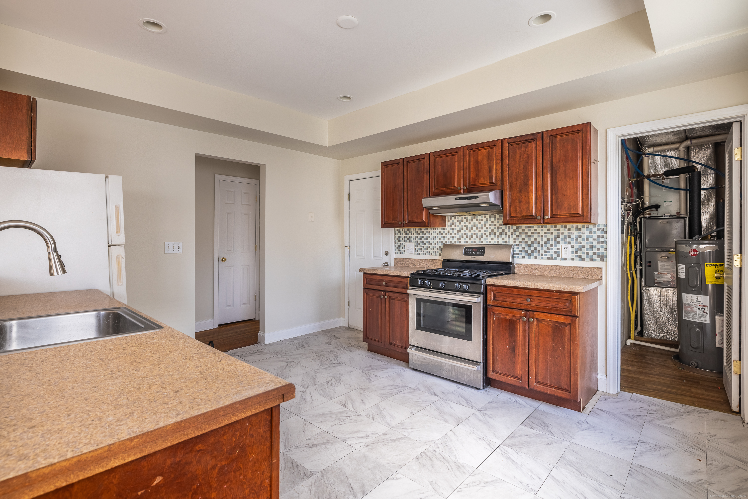 25 Hunting Street Bridgeport, CT 06606 - Photo 14 of 26 a kitchen with stainless steel appliances granite countertop a stove a sink and a refrigerator