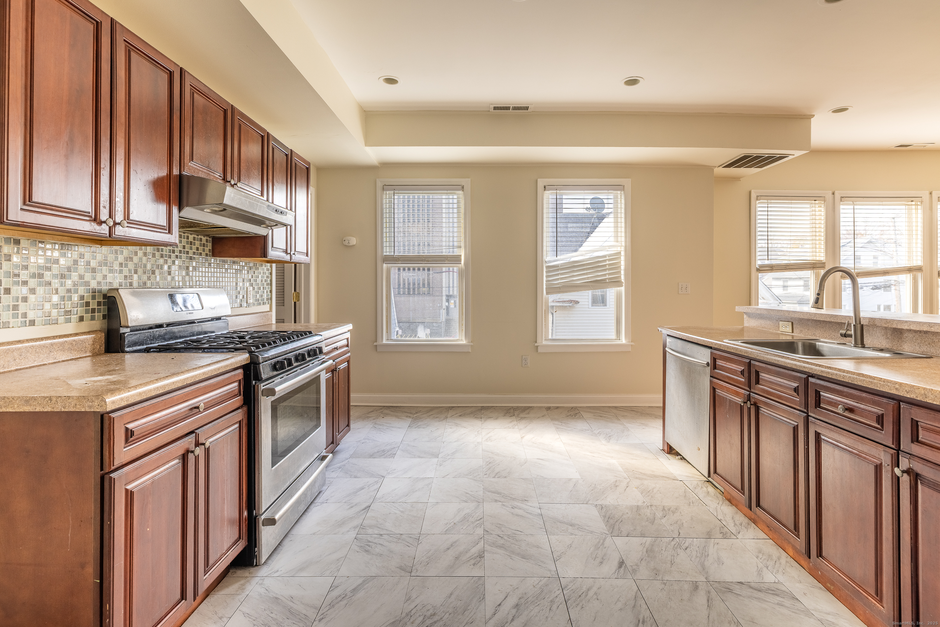 25 Hunting Street Bridgeport, CT 06606 - Photo 17 of 26 a kitchen with stainless steel appliances granite countertop a stove a sink dishwasher and a refrigerator