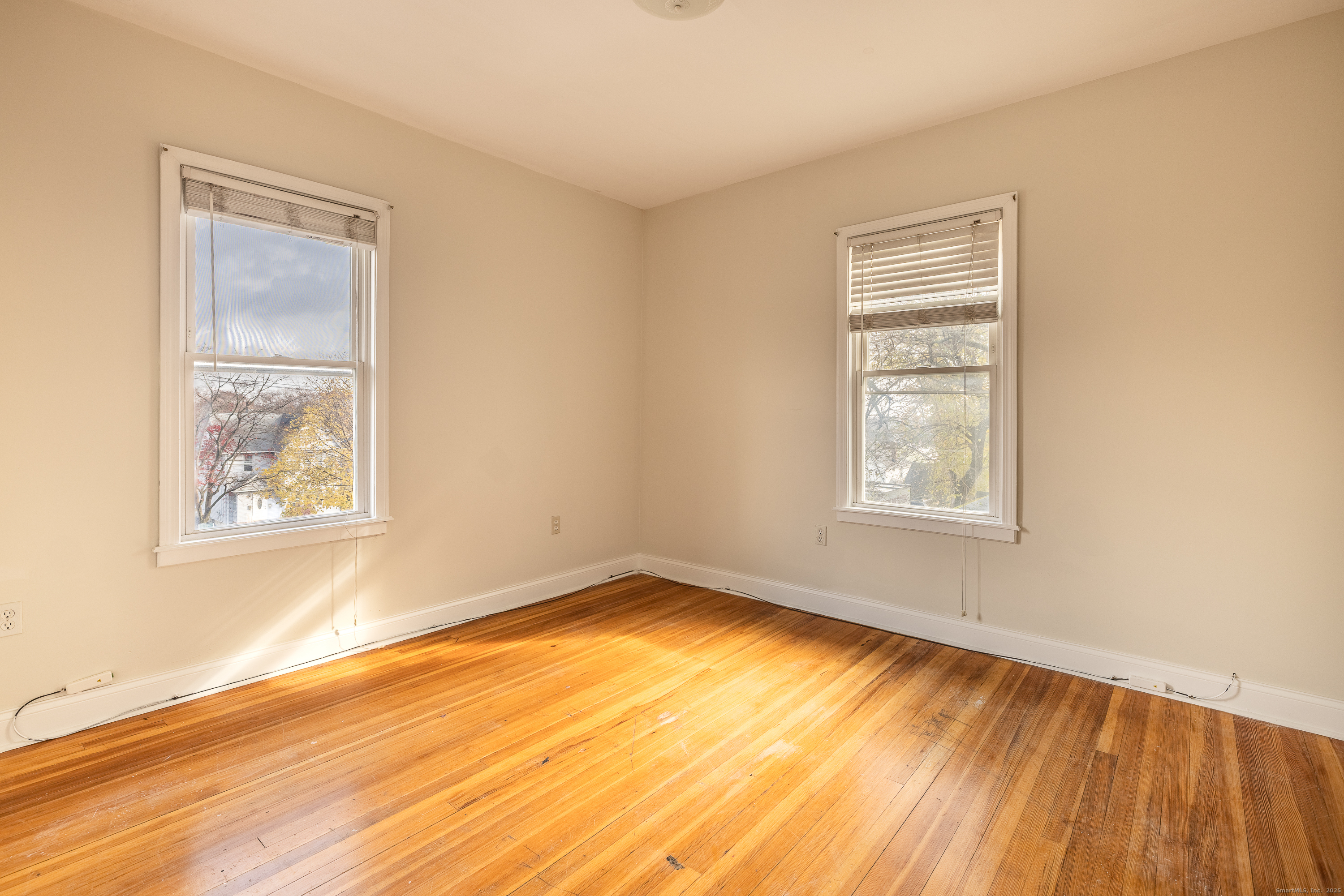 25 Hunting Street Bridgeport, CT 06606 - Photo 18 of 26 a view of an empty room with wooden floor and a window