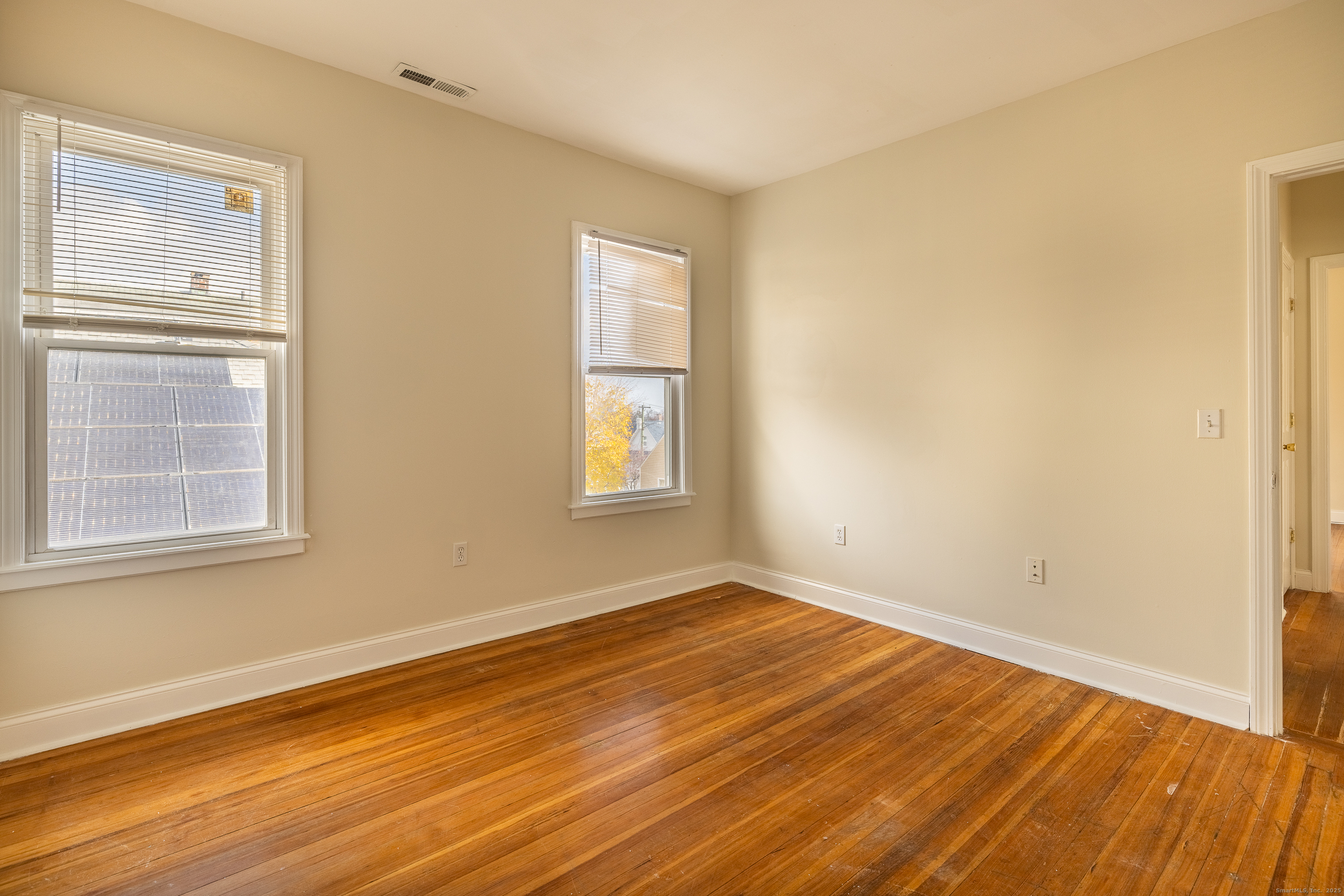 25 Hunting Street Bridgeport, CT 06606 - Photo 23 of 26 a view of an empty room with wooden floor and a window