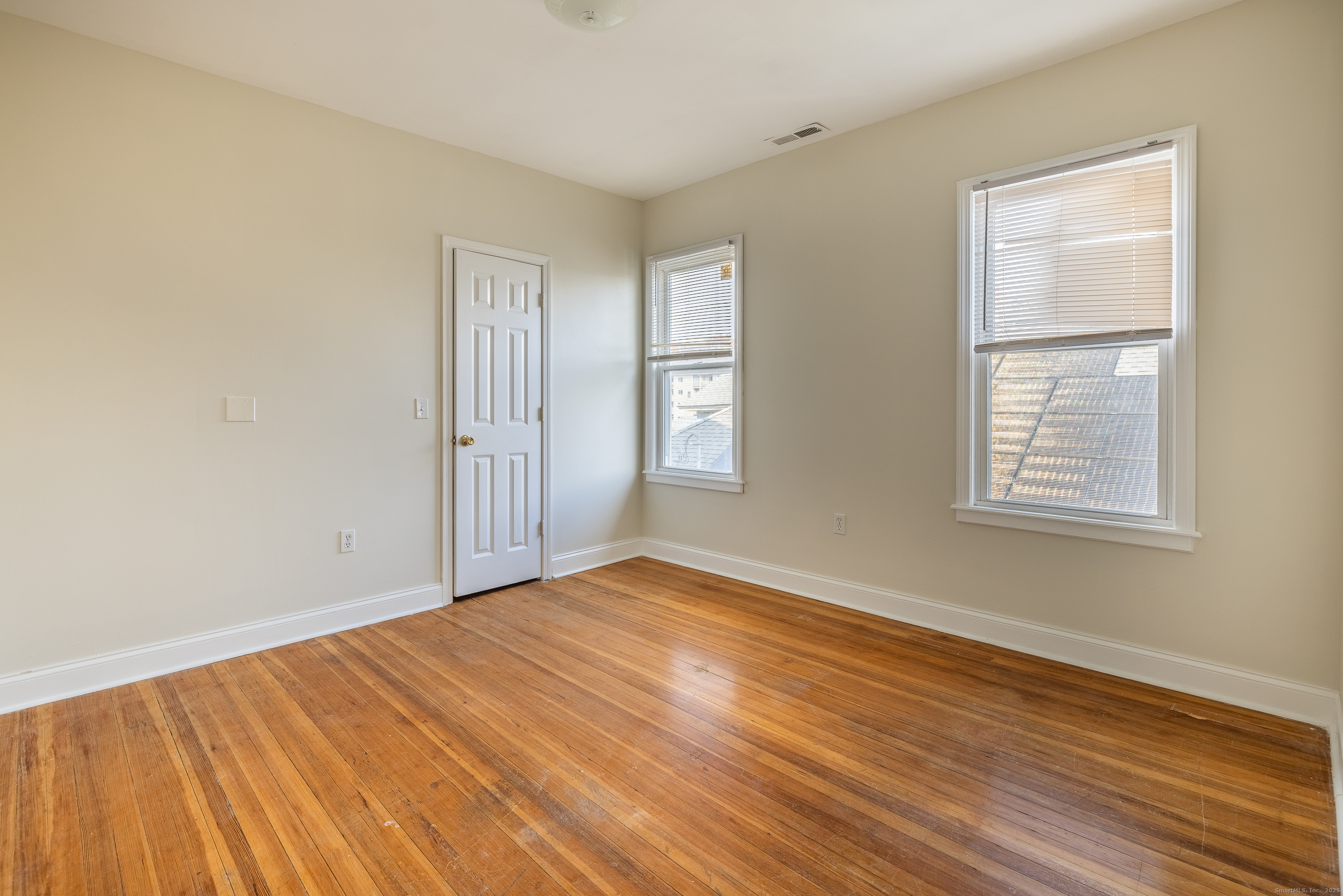 25 Hunting Street Bridgeport, CT 06606 - Photo 24 of 26 a view of an empty room with wooden floor and a window