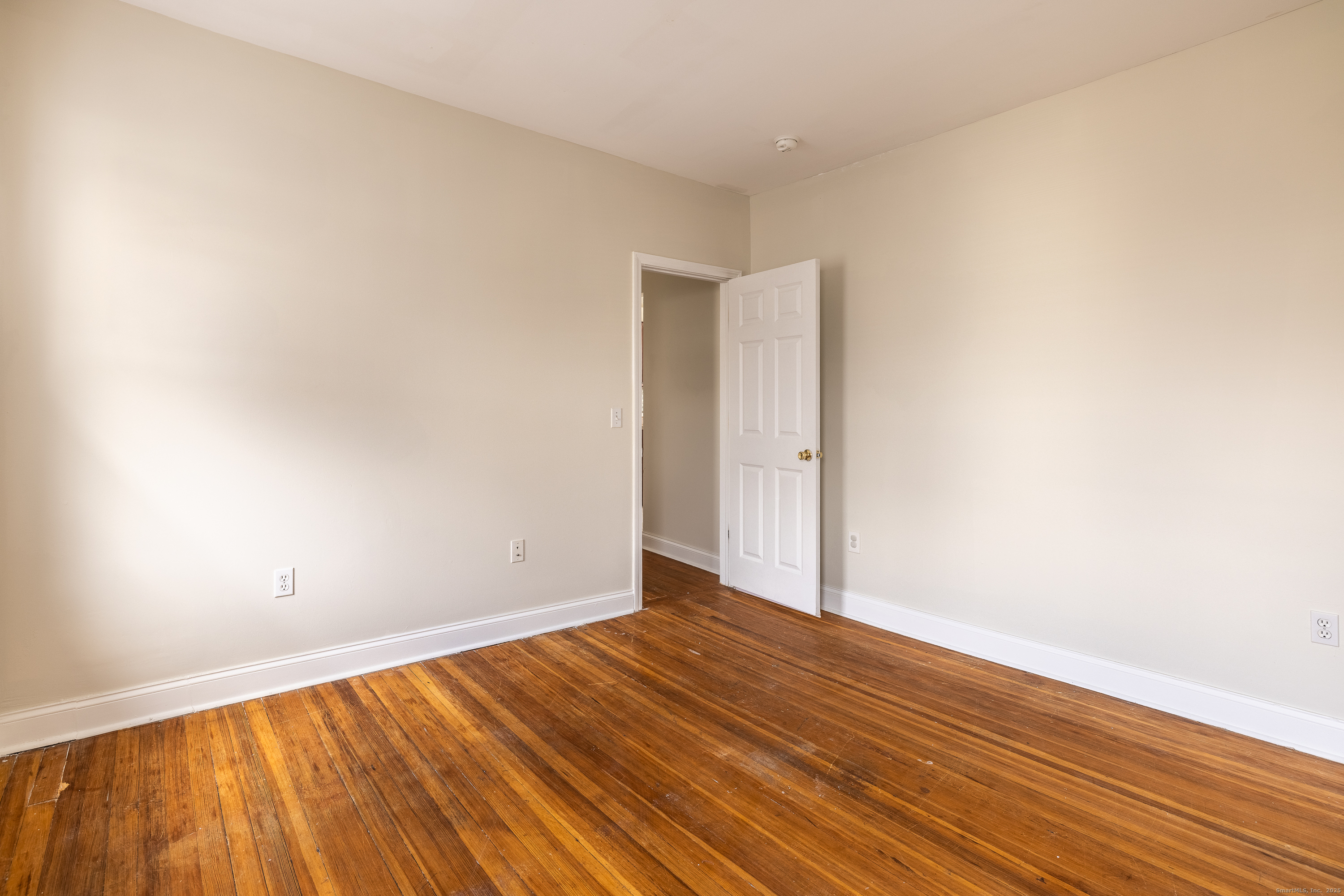 25 Hunting Street Bridgeport, CT 06606 - Photo 25 of 26 a view of an empty room with wooden floor