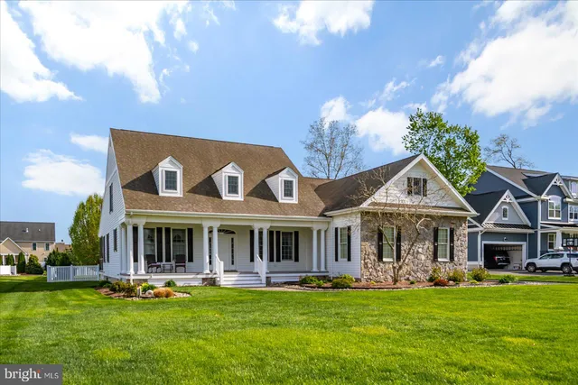 a front view of a house with swimming pool garden and patio