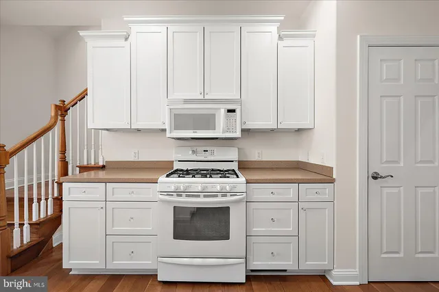 a front view of a house with yard and swimming pool