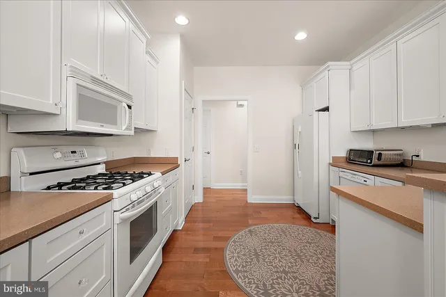 a view of a house with swimming pool and sitting area