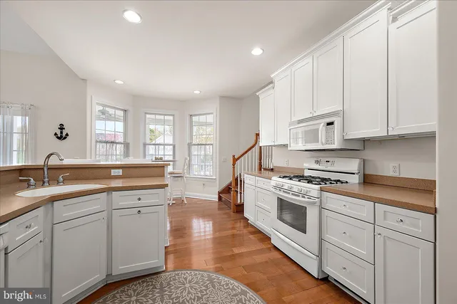 a view of a deck with table and chairs couches with wooden floor and fence