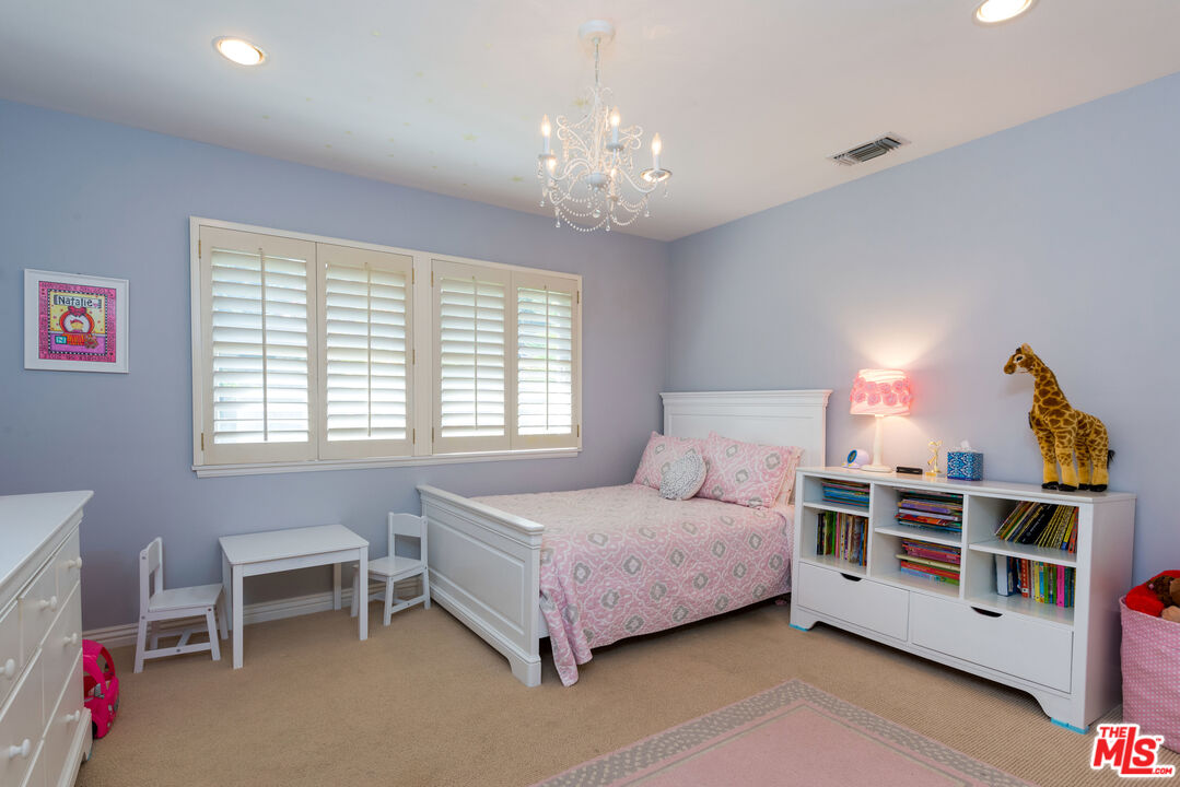 3632 Valley Meadow Road Sherman Oaks, CA 91403 - Photo 12 of 18 a bedroom with a bed and a window