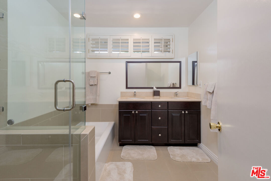 3632 Valley Meadow Road Sherman Oaks, CA 91403 - Photo 14 of 18 a bathroom with a tub sink and mirror