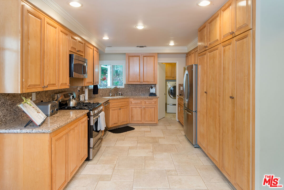 3632 Valley Meadow Road Sherman Oaks, CA 91403 - Photo 6 of 18 a kitchen with stainless steel appliances granite countertop a refrigerator and a sink