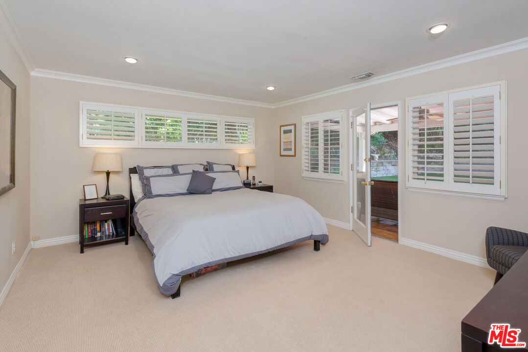 3632 Valley Meadow Road Sherman Oaks, CA 91403 - Photo 8 of 18 a bedroom with a bed and a dresser next to a window