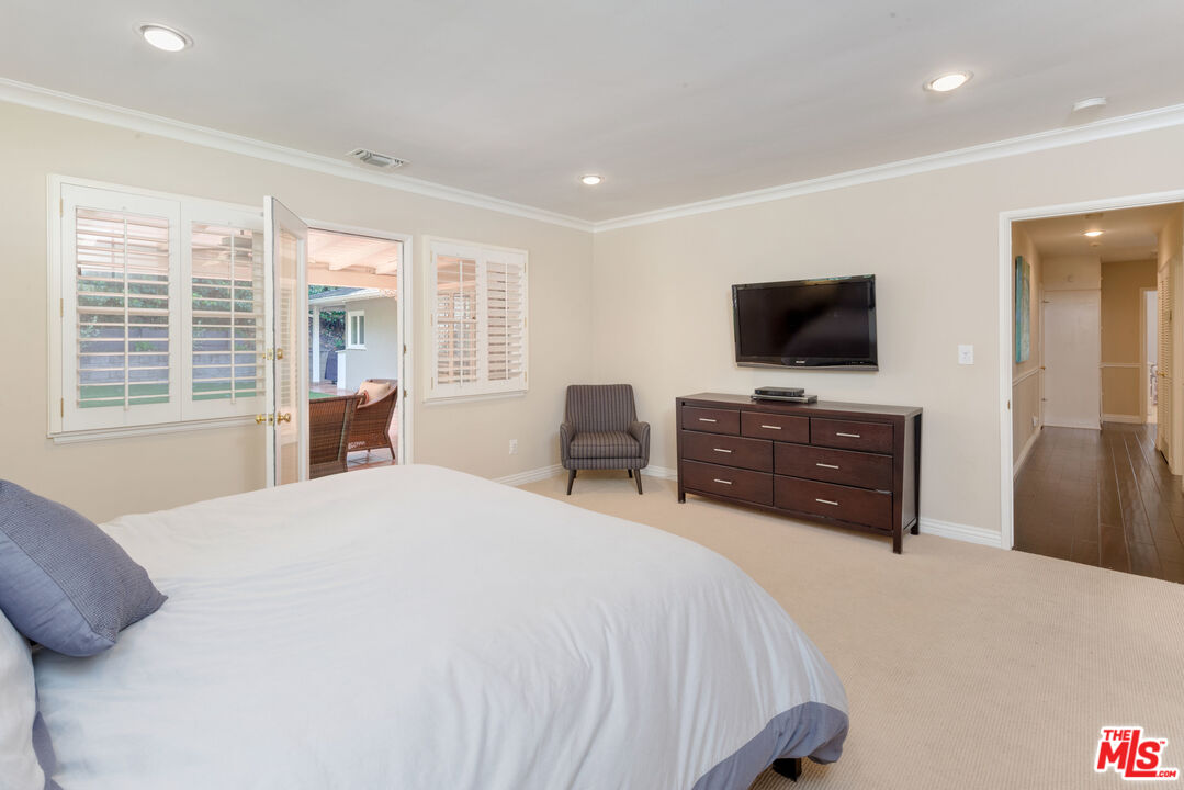 3632 Valley Meadow Road Sherman Oaks, CA 91403 - Photo 9 of 18 a bedroom with a bed and a flat screen tv