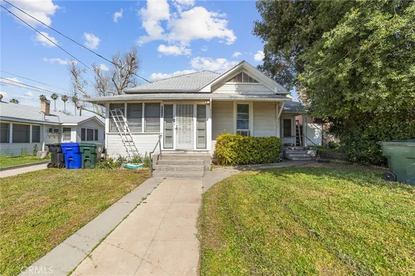 a front view of a house with a yard and porch