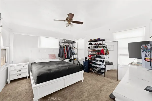 a bedroom with a bed and a flat tv screen