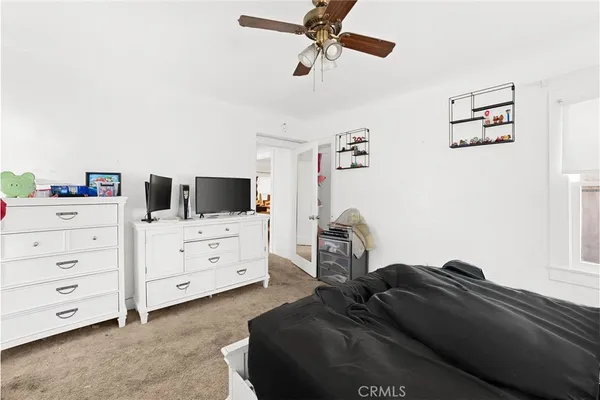 a bedroom with a bed and a television