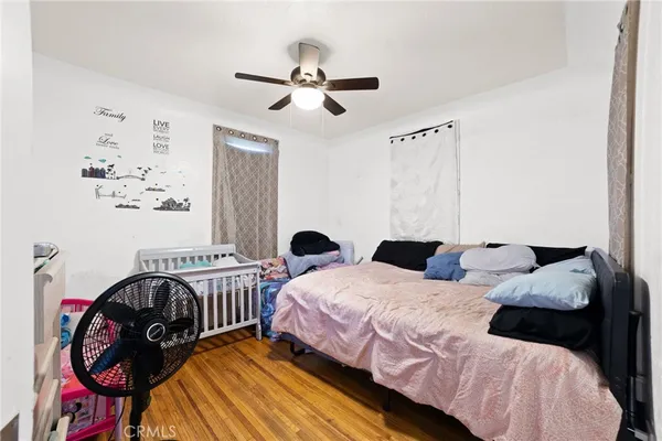 a bedroom with two beds and painting on the wall