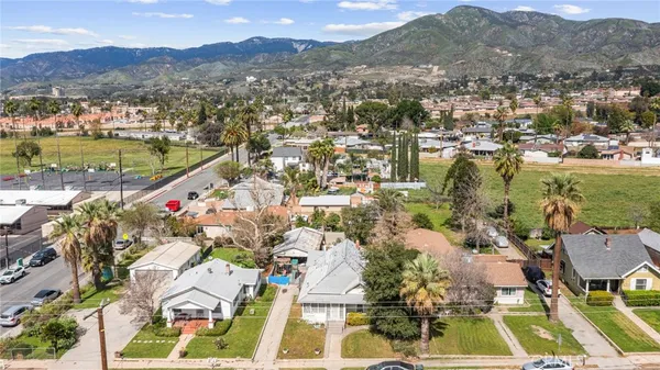 an aerial view of residential houses with outdoor space and river