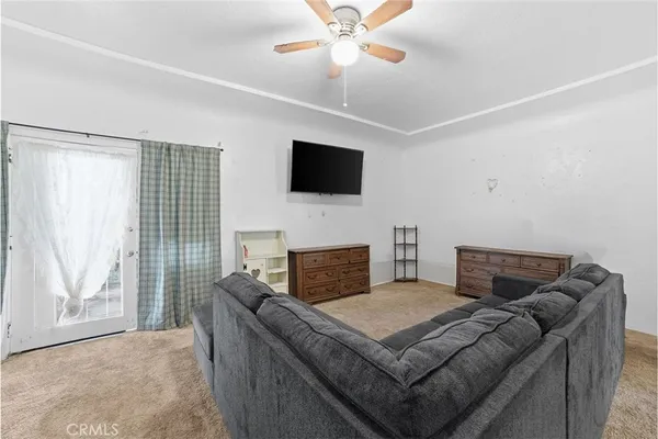 a bedroom with furniture and a flat screen tv