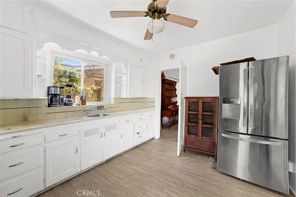 a kitchen with granite countertop a refrigerator and a sink