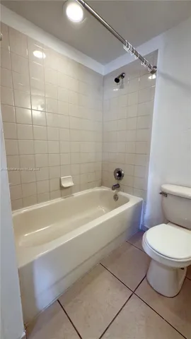 a bathroom with a bathtub and a toilet