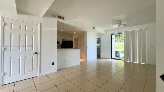 a view of a hallway with bathroom and a shower